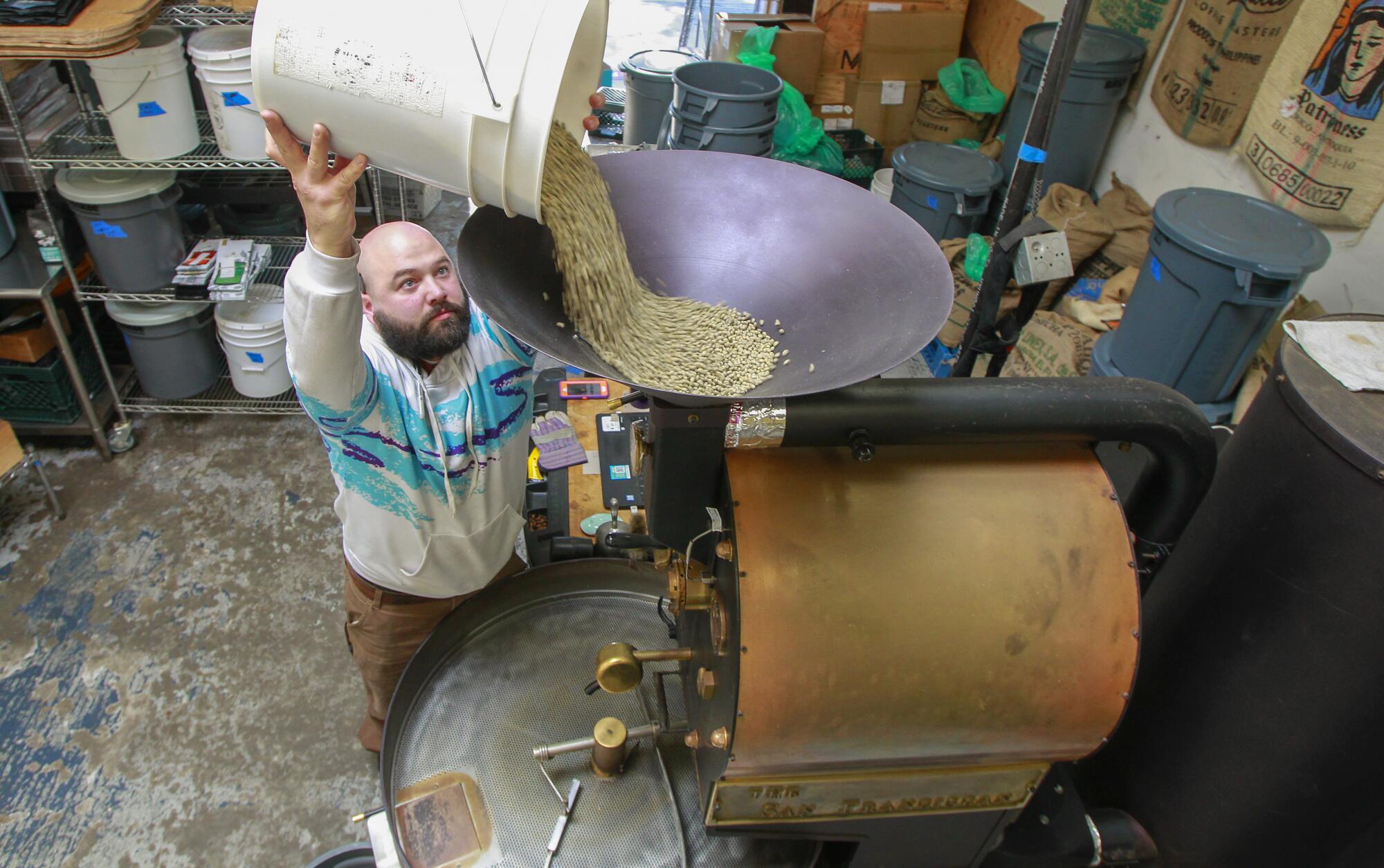 Head roaster Nick Berardi roasts a batch of Guatemalan coffee beans at the Mostra warehouse in Carmel Mountain Ranch.