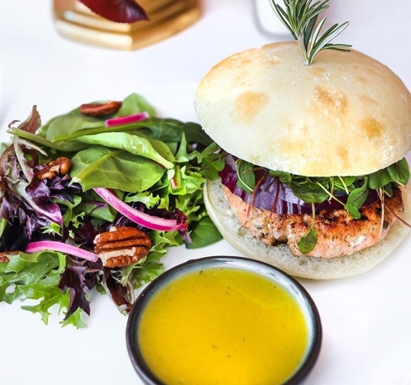 Grilled salmon burger on a potato bun is one of the meals featured on Pure Meal Prep San Diego's menu.