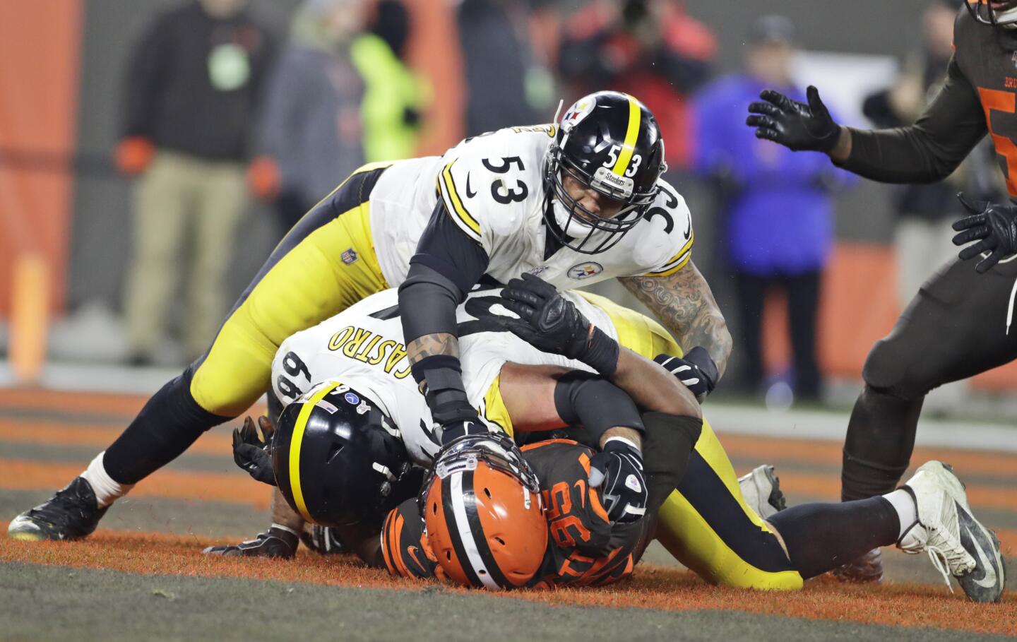 Browns defensive end Myles Garrett (95) is punched by Steelers center Maurkice Pouncey (53) and tackled by offensive guard David DeCastro (66) during a brawl in a game Nov. 14.