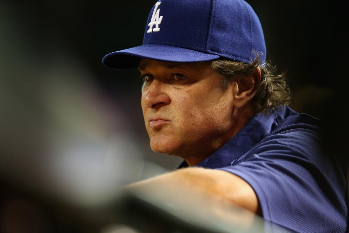 Dodgers Manager Don Mattingly watches his team play the Arizona Diamondbacks from the dugout on Aug. 27.