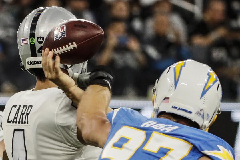 Inglewood CA, Monday, October 4, 2021 - Los Angeles Chargers defensive end Joey Bosa (97) forces a fumble.