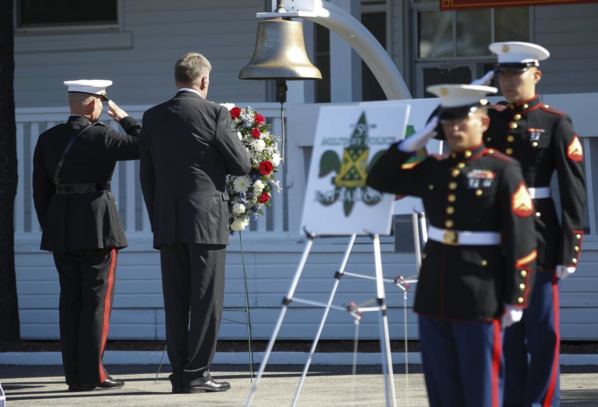 Retired Lt. Gen. Richard Natonski, right, and current commander Major Gen. Lawrence Nicholson salute a wreath for the fallen.
