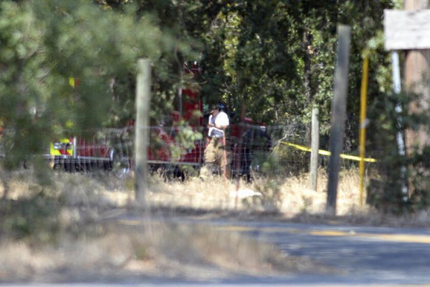 A paramedic with the Vacaville Fire Department walks near a crime scene along Cherry Glen Road where Sandra Coke's body was discovered.