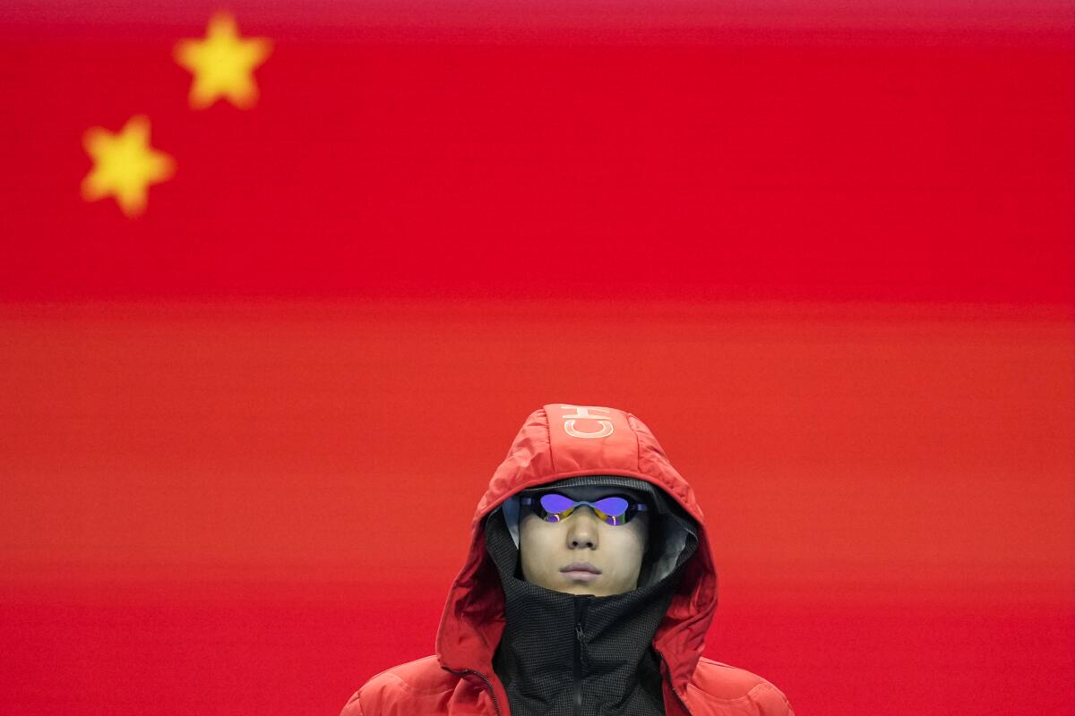 China’s Qin Haiyang prepares before competing in a men’s 100-meter breaststroke semifinal at the Paris Olympics.