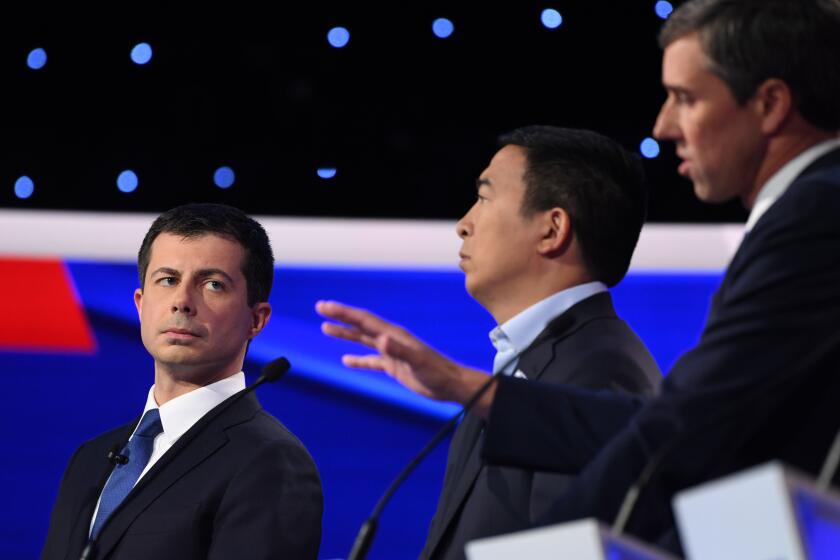 Democratic presidential hopeful Mayor of South Bend, Indiana Pete Buttigieg (L) looks on as former Texas representative Beto O'Rourke speaks during the fourth Democratic primary debate of the 2020 presidential campaign season co-hosted by The New York Times and CNN at Otterbein University in Westerville, Ohio on October 15, 2019. (Photo by SAUL LOEB / AFP) (Photo by SAUL LOEB/AFP via Getty Images)