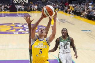 Los Angeles Sparks forward Dearica Hamby, center, shoots as Seattle Storm forward Nneka Ogwumike, left, and center Ezi Magbegor defend during the first half of a WNBA basketball game, Wednesday, Sept. 11, 2024, in Los Angeles. (AP Photo/Mark J. Terrill)