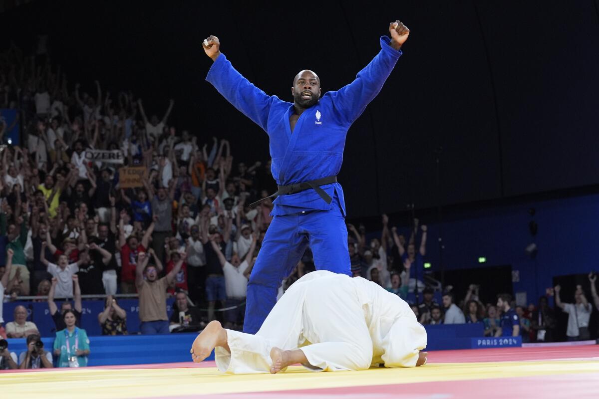 France's Teddy Riner celebrates after defeating South Korea's Min-Jong Kim.