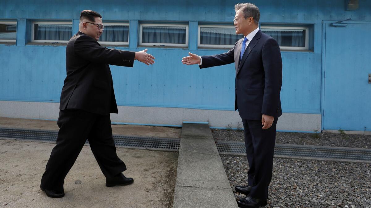 North Korean leader Kim Jong Un, left, and South Korean President Moon Jae-in meet at the military demarcation line in the village of Panmunjom on April 27.