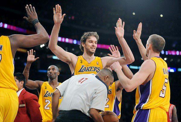 Lakers center Pau Gasol (center) celebrates a 112-110 victory over the Houston Rockets with point guard Steve Blake (5) on Tuesday night at Staples Center.