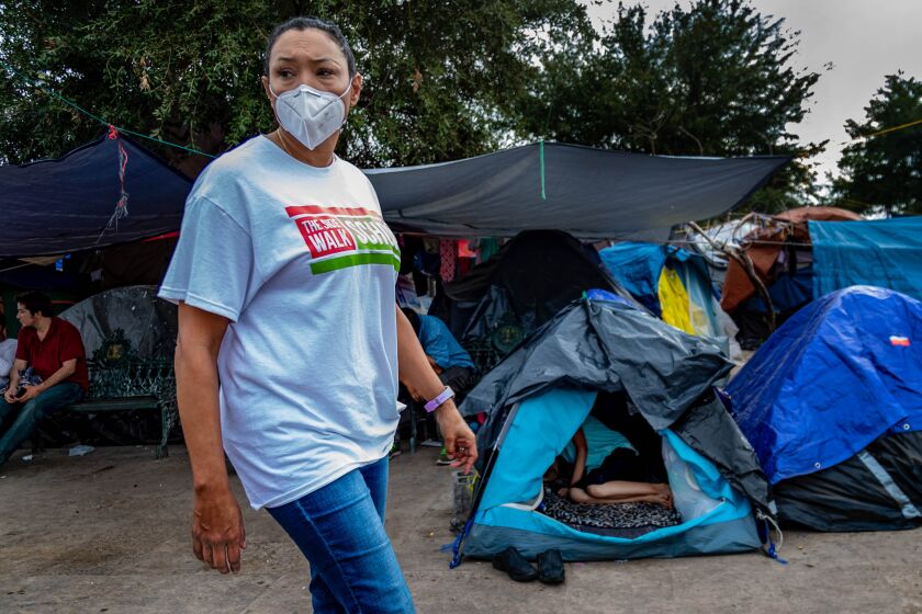 Felicia Rangel-Samponaro walks through the Plaza Las Americas migrant tent camp on December 6, 2021 in Reynosa, Mexico. 