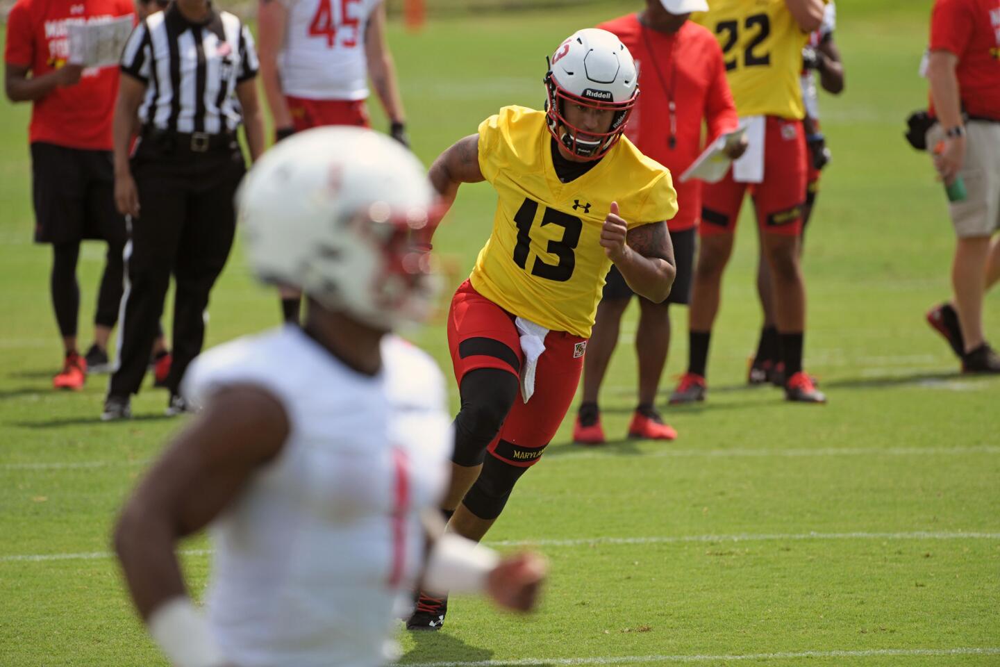 Tyler DeSue, University of Maryland QB, runs after handing off the ball during a drill at Terps training camp on media day.