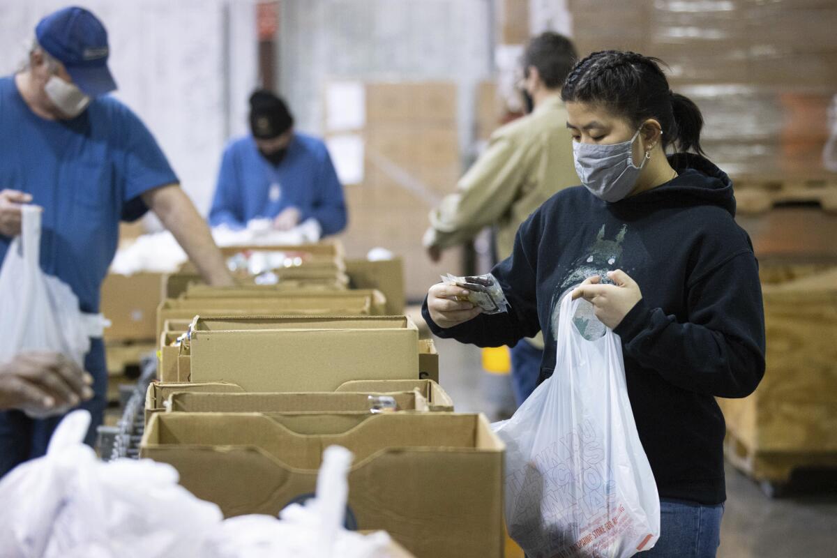 Volunteers fill bags at a Feeding America food bank in Kentucky in 2022. 