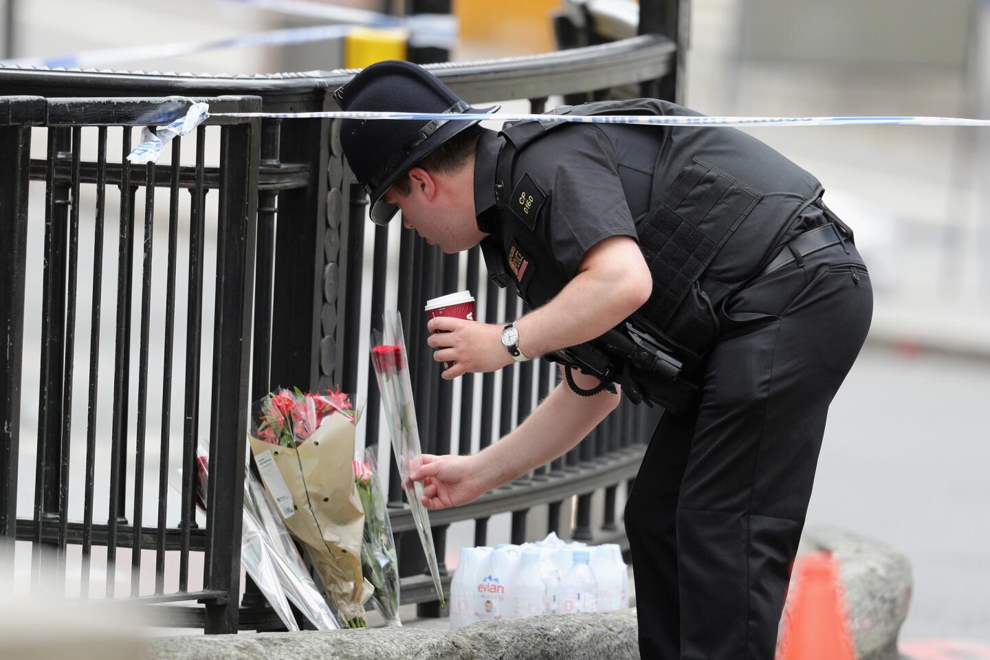 A police officer places a rose at the scene of last night's terrorist attack on London Bridge on June 4, 2017 in London, England.