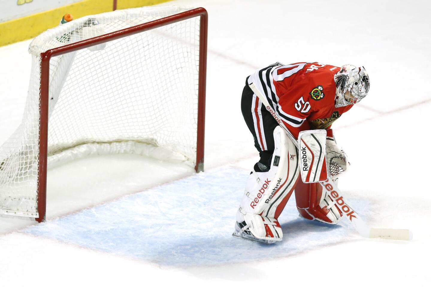 Corey Crawford hangs his head after Bruins center Gregory Campbell scores a goal in the second period.