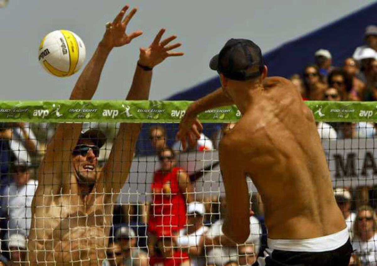 Phil Dalhausser, right, spikes ball past Matt Prosser at the 2010 Hermosa Beach Open.