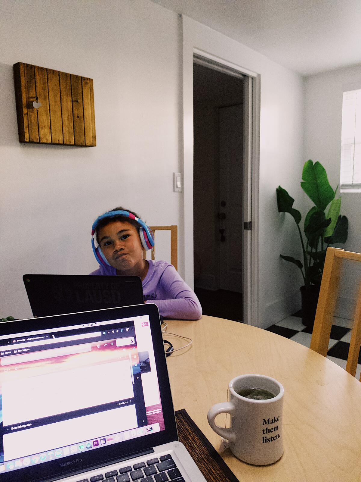 Fiona Rogue Johnson, 6, of Los Angeles does her schoolwork while her father works from home.