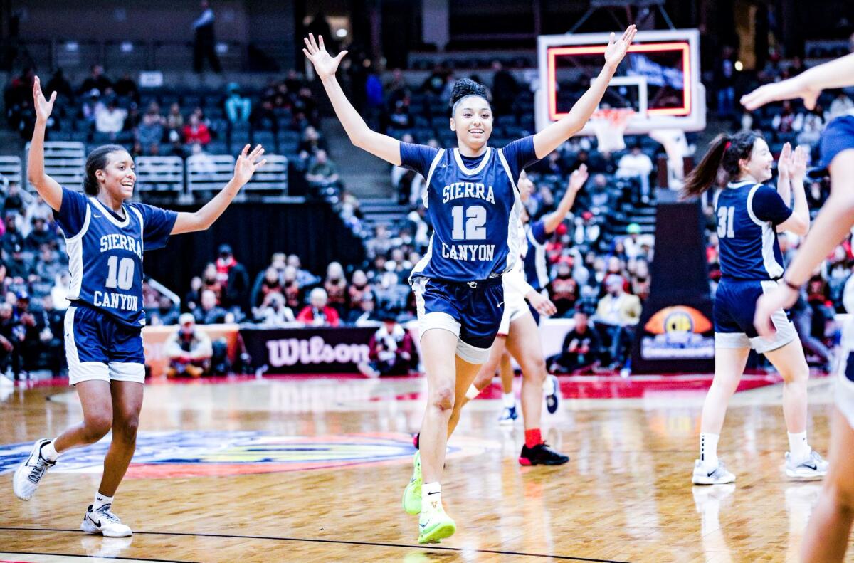 Juju Watkins of Sierra Canyon celebrates the Open Division championship with Izela Arenas.