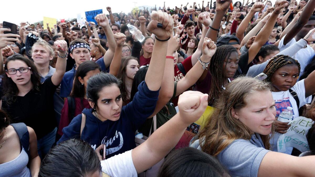 Students from area high schools rally at Marjory Stoneman Douglas High School in Parkland, Fla., last month. On March 14, nationwide walkouts are planned.