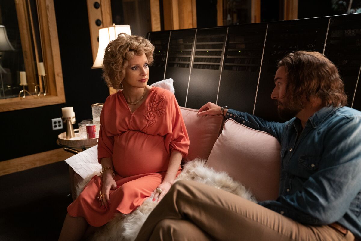 Tammy Faye Bakker (Jessica Chastain) and her music producer (Mark Wystrach) share a look in "The Eyes of Tammy Faye."
