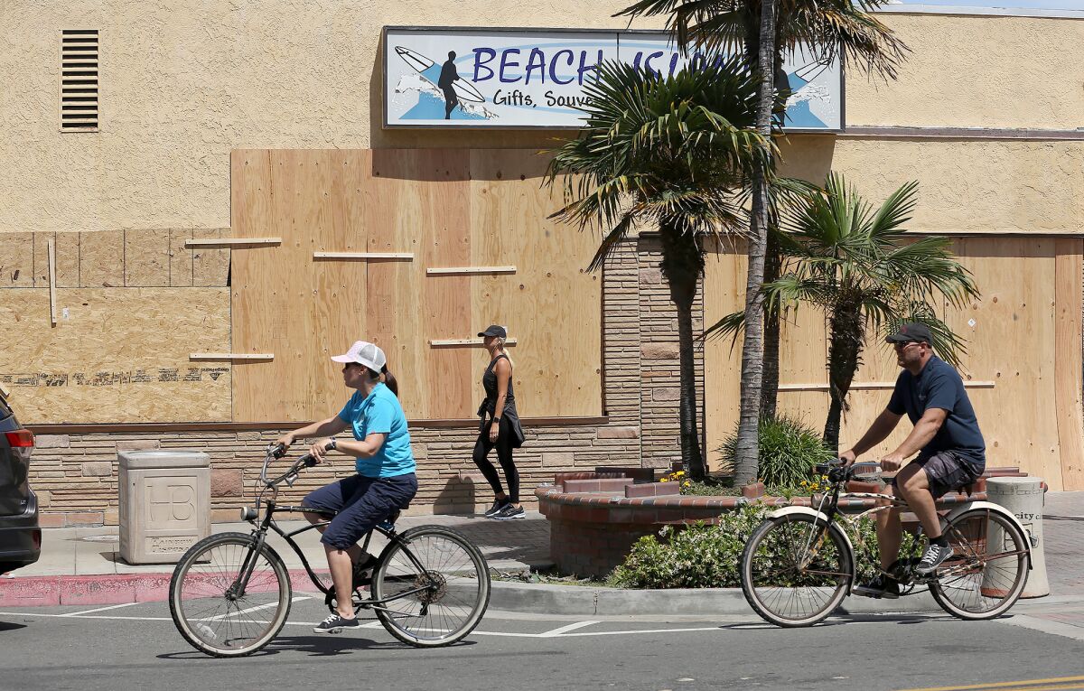 Plywood panels protected several storefronts during Sunday's protest in downtown Huntington Beach.