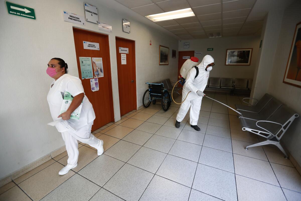 Workers sanitize a public hospital in Jalisco.