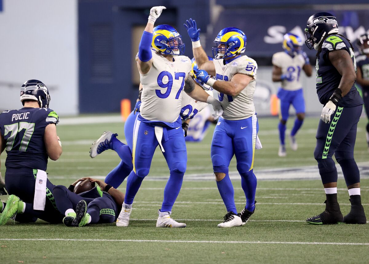 Rams defensive end Morgan Fox and inside linebacker Troy Reeder celebrate after a sack.