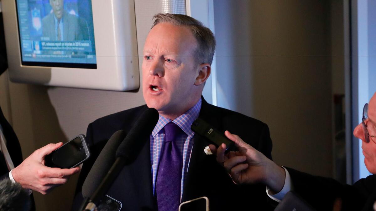 White House press secretary Sean Spicer speaks to reporters on Air Force One Thursday. Spicer said that taxing imports from Mexico would generate $10 billion a year and "easily pay for the wall" that President Trump wants to build along the southern border.