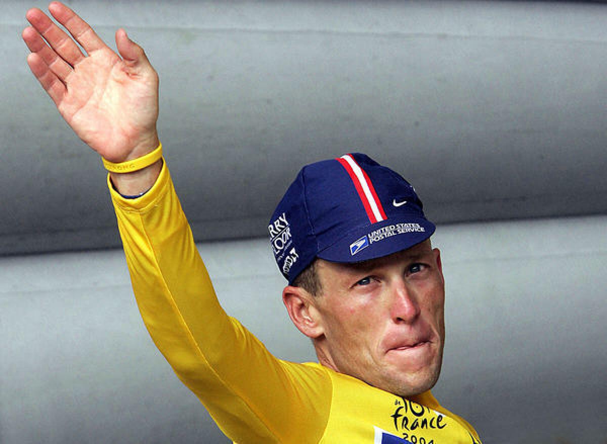 Lance Armstrong waves to the crowd during one of his victories in the Tour de France.
