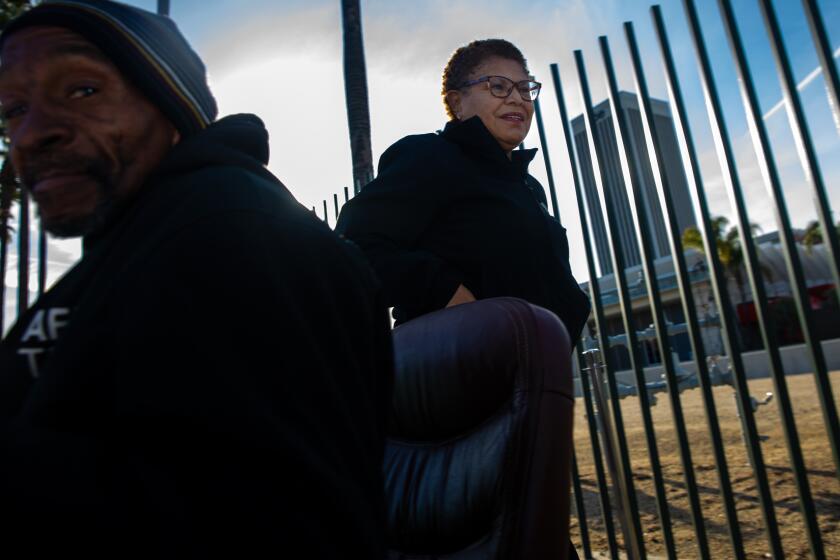 Los Angeles, CA - February 16: Mayor Karen Bass, right, visits homeless encampment to observe her "Inside Safe" initiative to move houseless living in tents behind Academy Museum of Motion Pictures on Thursday, Feb. 16, 2023 in Los Angeles, CA. (Irfan Khan / Los Angeles Times)
