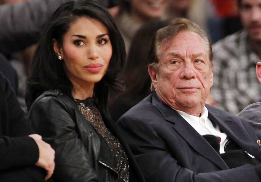 Los Angeles Clippers owner Donald Sterling, right, and V. Stiviano watch the Clippers play the Los Angeles Lakers in 2011.