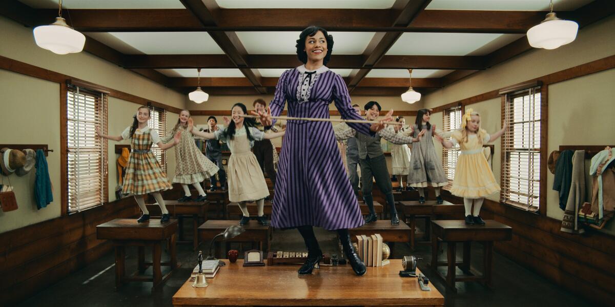 A schoolteacher and her students dancing on their desks