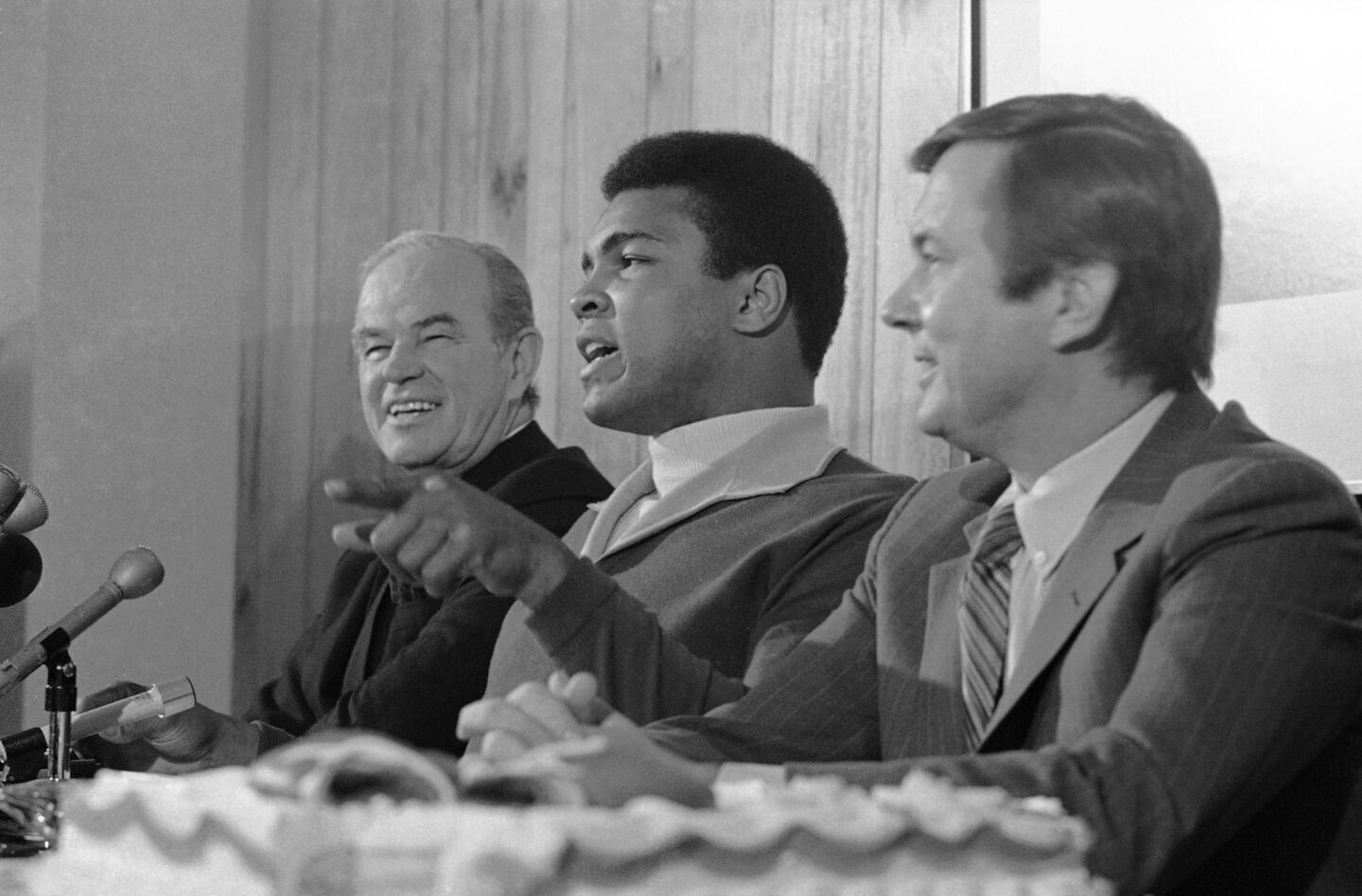 Muhammad Ali is flanked by Jack Kent Cooke, left, and Jerry Perenchio, financial backers of his title fight with Joe Frazier, at a news conference in L.A. in 1971.