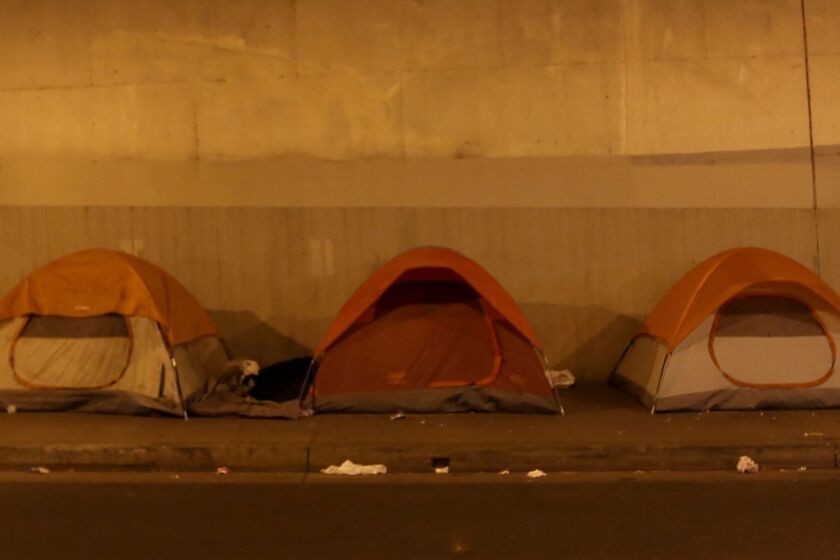 Tents are pitched on a sidewalk beneath a Hollywood overpass early in the morning on Oct. 28.