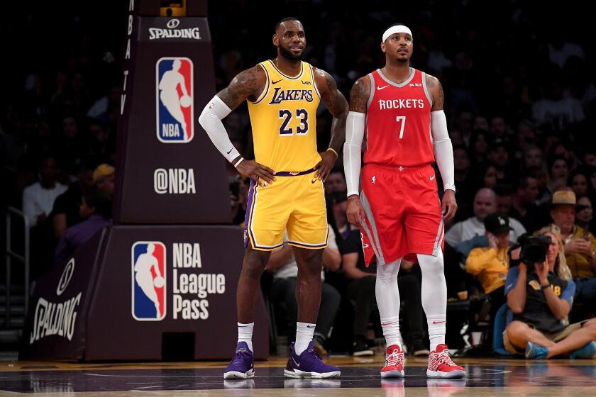 Lakers forward LeBron James and Rockets forward Carmelo Anthony chat during a break in play on Oct. 20, 2018, at Staples Center.