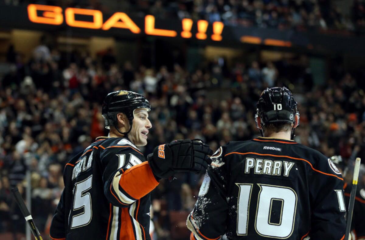 Ducks teammates Ryan Getzlaf and Corey Perry celebrate a goal by Getzlaf during a 4-0 victory over the Calgary Flames last month at the Honda Center.