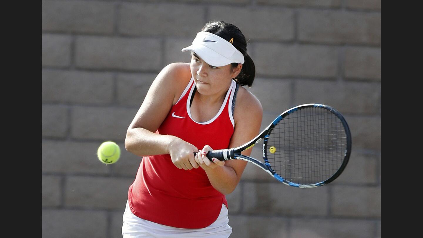 Burroughs' Jackie Samsell hits a backhand return in a singles match against Glendale in a Pacific League girls' tennis match at Glendale High School on Thursday, October 19, 2017.