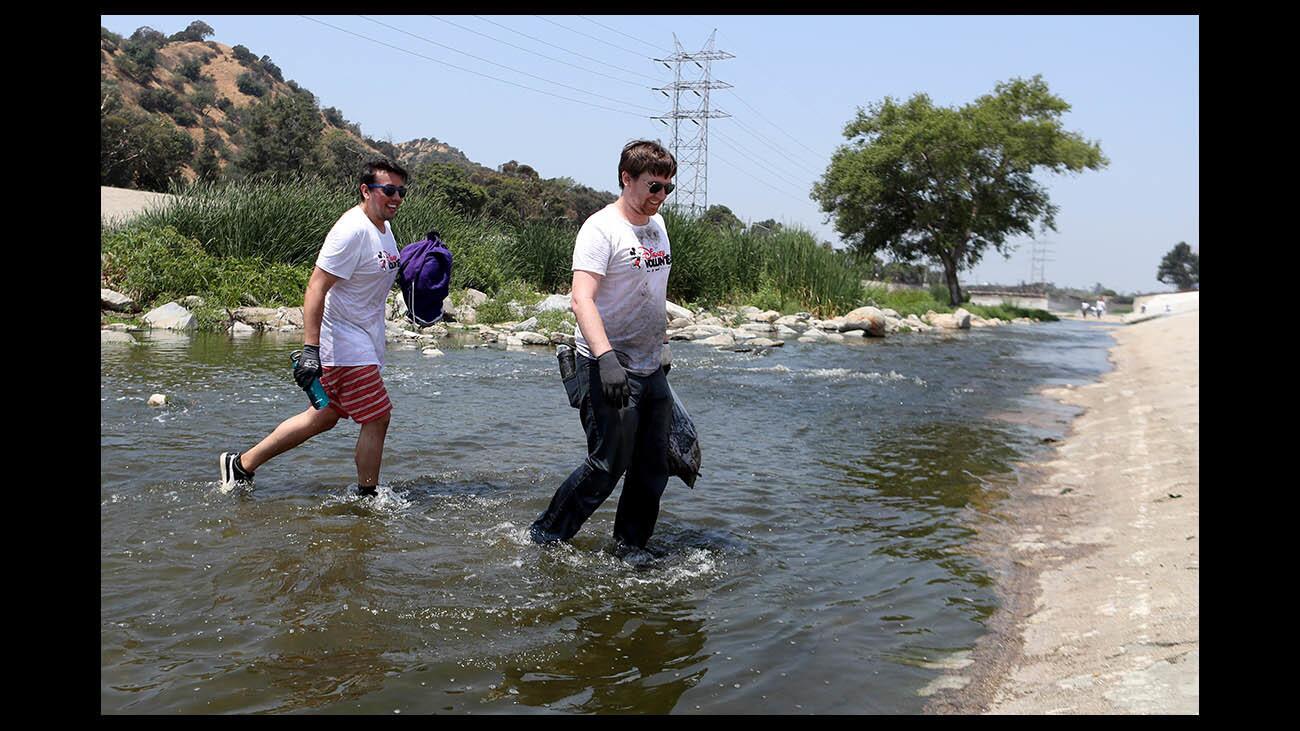 Disney Company volunteers like Javier Descalzo, left, and Ryan Willis, right, fanned out to clean up the L.A. River next to Bette Davis Park, in Burbank on Thursday, June 7, 2018. About 90 volunteers spent two hours removing all types of debris from the river during the annual Friends of the L.A. River clean up event.
