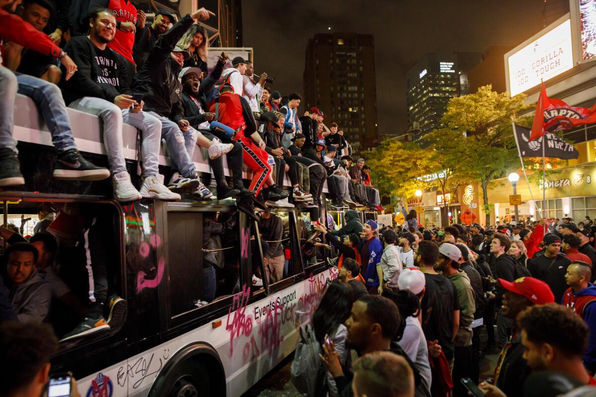 Some Raptors fans celebrated atop a bus on Yonge Street in Toronto after their team beat the Golden State Warriors in Game Six of the NBA Finals.
