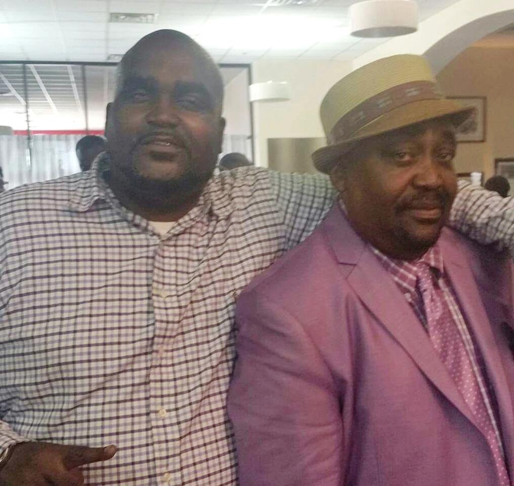 This photo provided by Parks & Crump shows Terence Crutcher, left, with his father, Joey Crutcher.