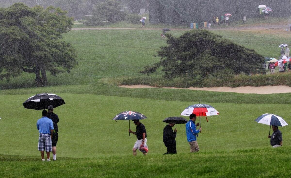 The umbrellas were out during a rainy practice round for the U.S. Open on Tuesday.