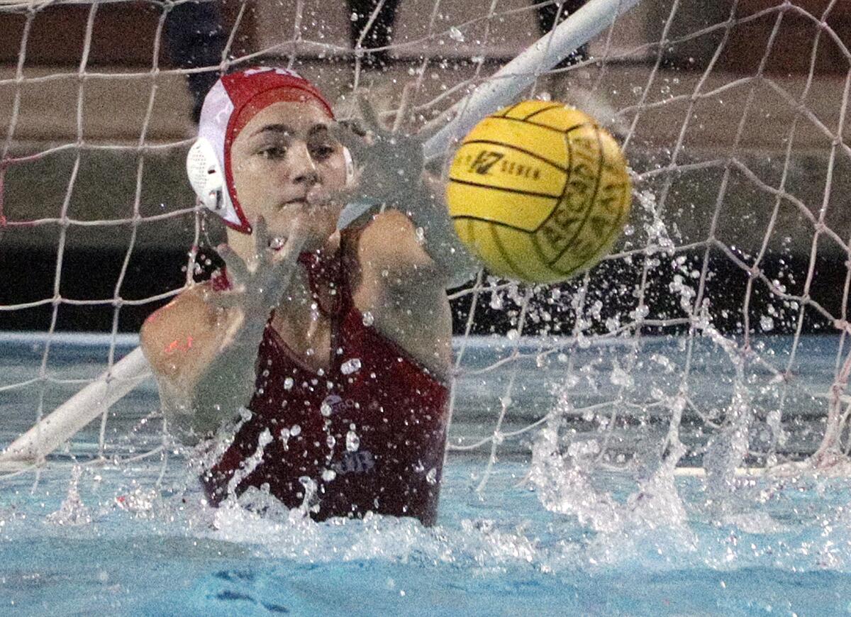 Burroughs' goalie Emanuella Nathan reaches out and stops an Arcadia shot in the Pacific League girls' water polo championship at Arcadia High School on Thursday, February 6, 2020. Arcadia won the match in the second overtime.
