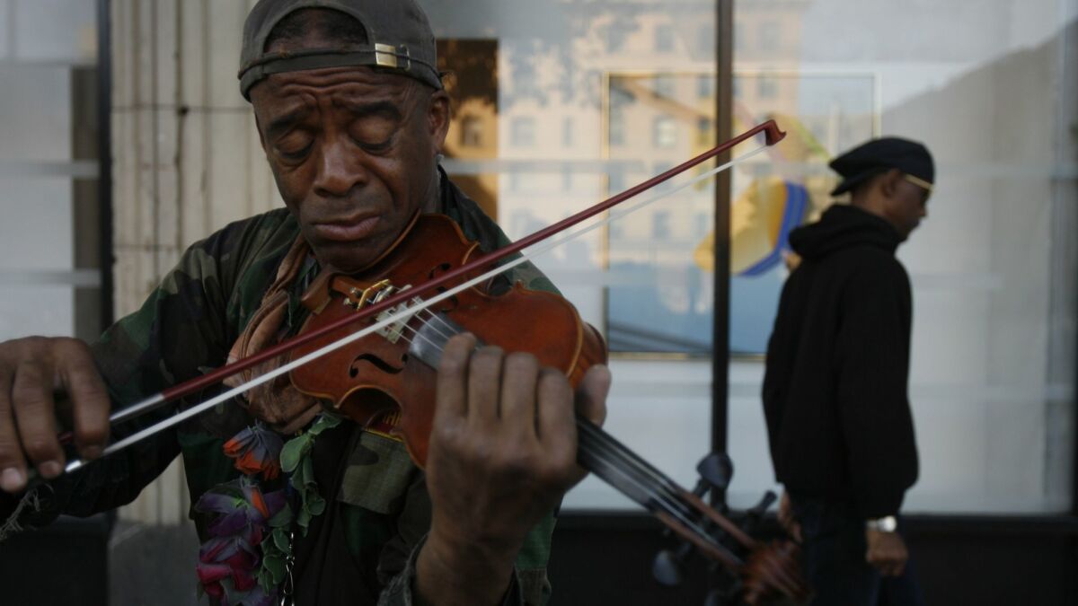 Nathaniel Ayers plays the violin on 4th Street in downtown Los Angeles in 2008.
