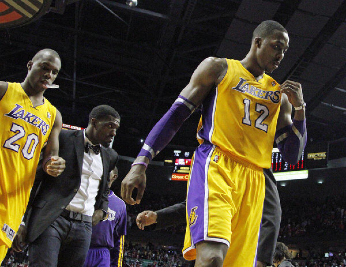 Lakers Dwight Howard and Jodie Meeks exit the court after a 116-106 loss to the Trail Blazers in Portland.