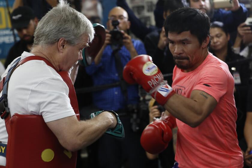 Manny Pacquiao, right, works out with trainer Freddie Roach at a boxing club in Los Angeles, Wednesday, Jan. 9, 2019. Pacquiao is scheduled to defend his WBA welterweight title against Adrien Broner on Jan. 19, 2019, in Las Vegas.