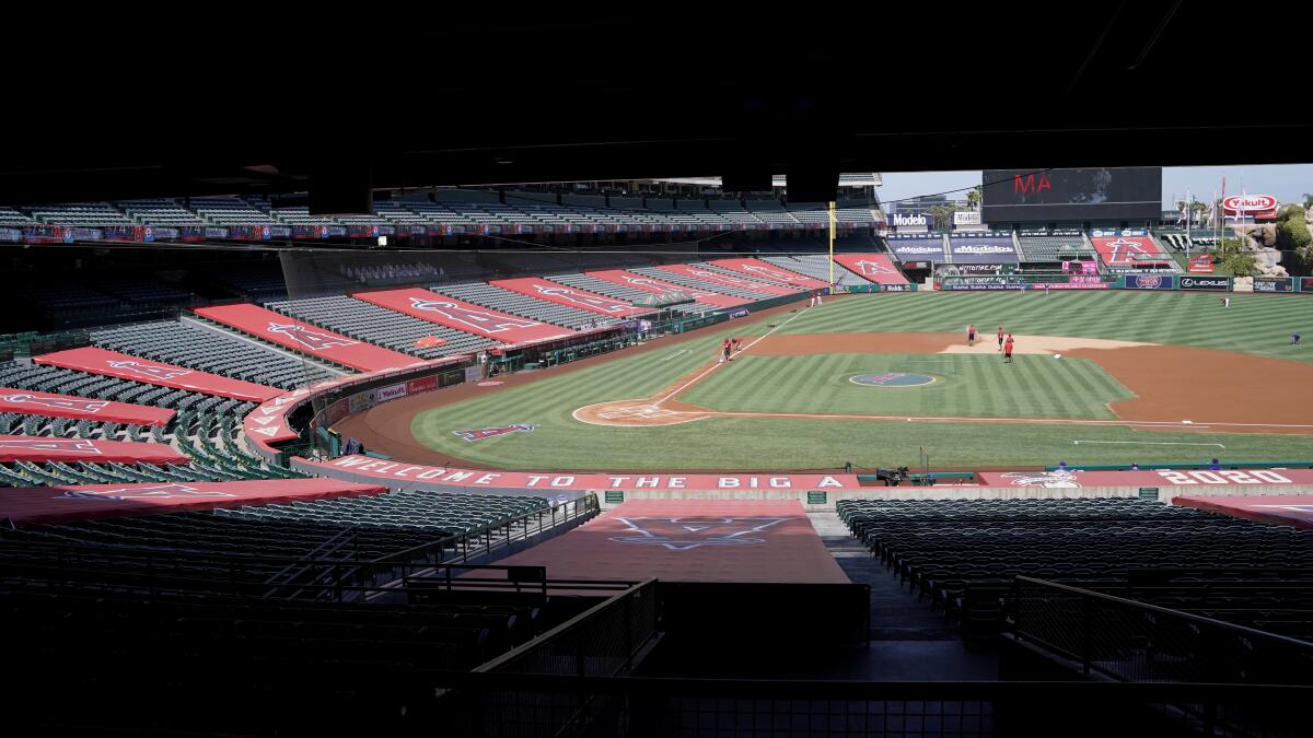 Grounds crew work to prepare Angel Stadium for a baseball game against the Rangers.