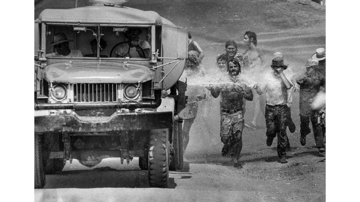 Sept. 7, 1975: When the water truck went out to wet the dust on the track at Riverside International Raceway, a crowd of spectators chased after the truck to cool off in its spray.