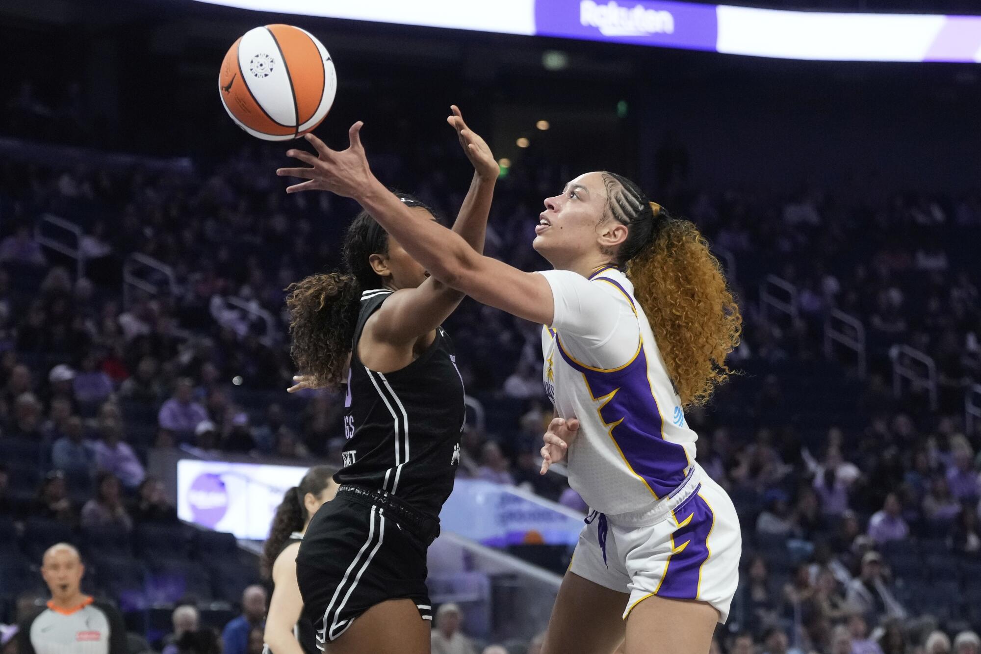 Sparks forward Dearica Hamby, right, attempts a left-handed layup while guarded by Valkyries forward Monique Billings.