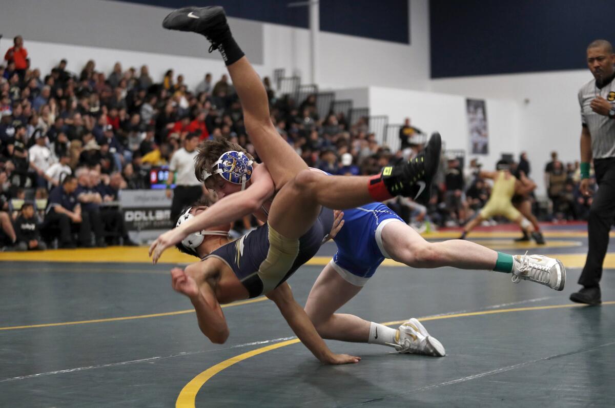 Fountain Valley's TJ McDonnell slams his opponent as he competes for fifth place in a 138-pound medal-round match during the CIF Southern Section Masters wrestling meet at Sonora High in La Habra on Saturday.