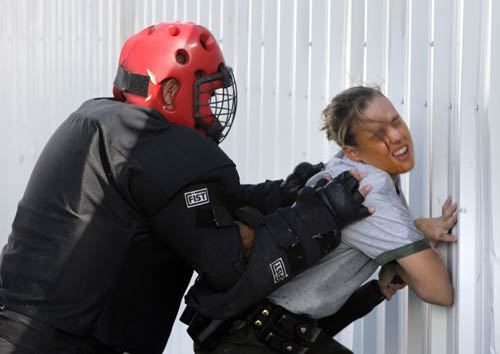 Seconds after being shot with pepper spray, Shannon Gorey fights with an aggressive suspect, played by an instructor.
