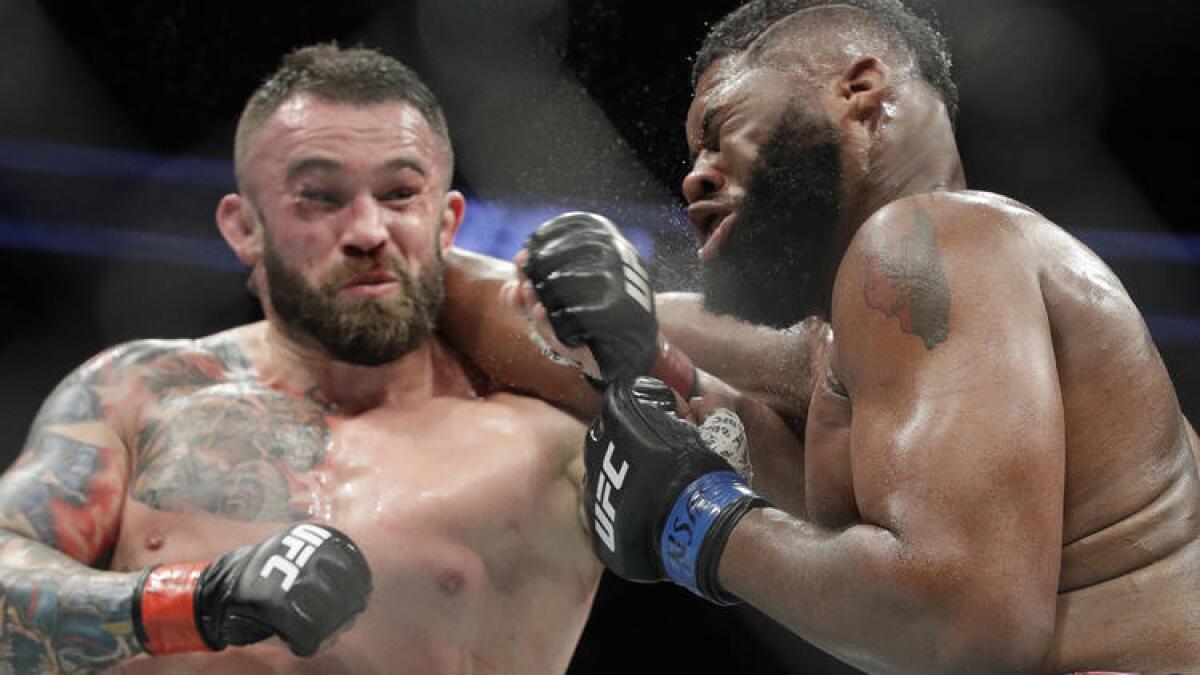 Daniel Omielanczuk, left, and Curtis Blaydes trade punches during their heavyweight fight at UFC 213.